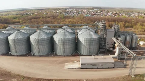 Grain elevator silos storing wheat and corn in rural landscape Stock Footage 309776065