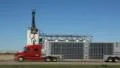 Grain elevator with train. Dunmore, Alberta, Canada. Red truck goes by. HD Footage