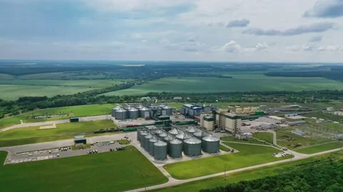 Grain elevators on beautiful landscape. Agricultural factory with granaries.  Stock Footage 134775159