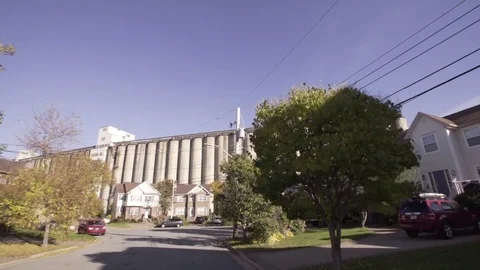 Grain Elevators Behind Neighborhood Drive By Stock Footage 71345999