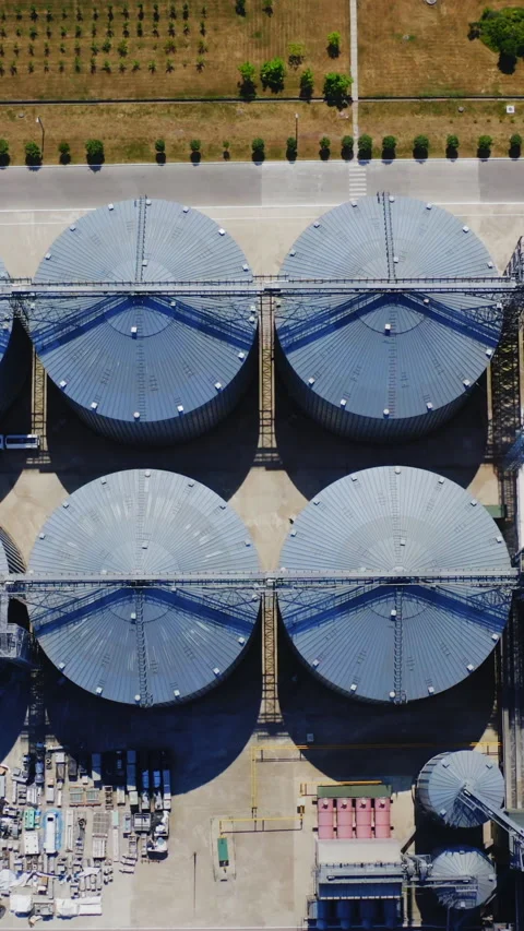 Grain elevators on field. Agriculture grain silos storage tanks.  Stock Footage 272686049