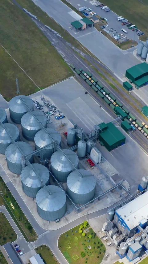 Grain elevators on field. Modern plant for agricultural business.  Stock Footage 296771673
