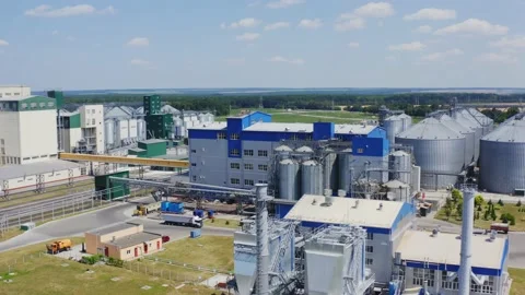 Grain elevators on nature background. Granary on a modern territory. Stock Footage 136947332