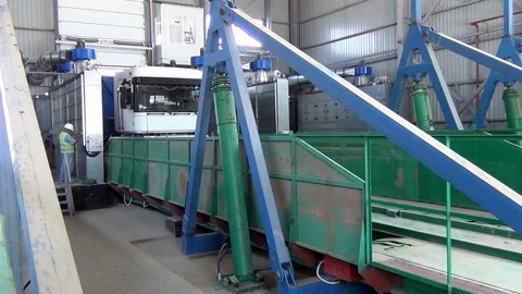 Grain flow entering the elevator bunker when unloading a truck for Stock Footage 112658129