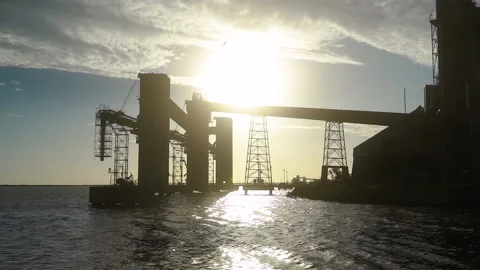 Grain Loading Terminal In Silhouette Against Bright Sun. Port Of Ingeniero 스톡 동영상 151217230