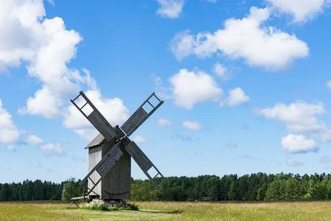 Grain mill on the winter landscape. Windmill and natural background pattern Stock Photos