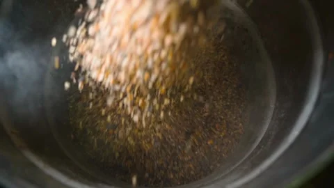 A grain mixture is being poured into a barrel of grain to feed chickens, close Stock Footage 323373279