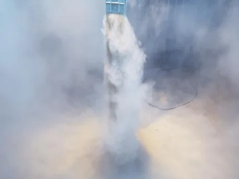 Grain products dust commencement of loading on ship into the hold Stock Photos
