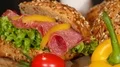 grain roll bun with salami and paprika on turntable close 4k or 4k+ Resolution