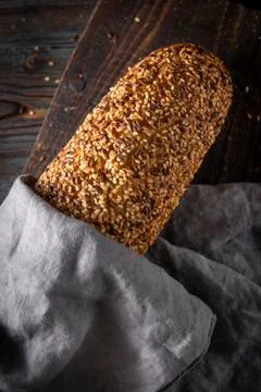 Grain rye bread on a grey napkin on a grey background, top view, Stock Photos