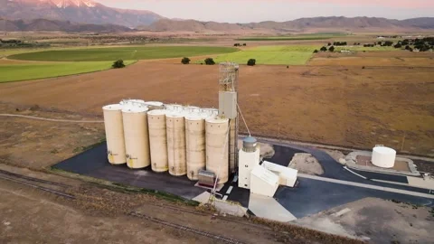 Grain silo elevator in a farming community and valley in Utah - aerial Stock Footage 278020535