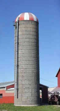 Grain Silo with Red Barns Under Clear Blue Sky Stock Photos