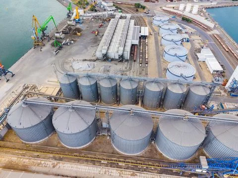 Grain storage facility located by the water with various containers and mac.. Stock Photos