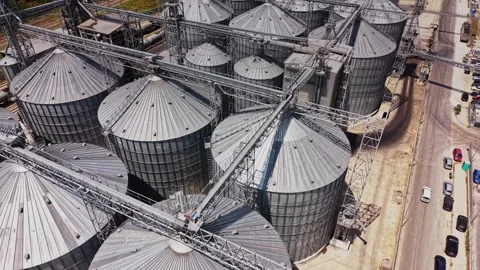 Grain storage facility with silos and loading equipment in operation Stock Footage 340382848
