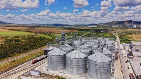 Grain storage facility with silos and freight trains in the countryside Stock Footage 341327889