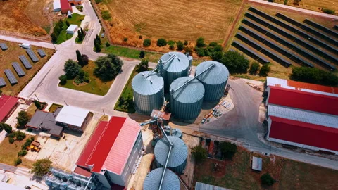 Grain storage silos beside solar panel arrays Stock-Footage 340079536