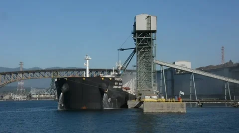 Grain Terminal Medium shot of ship at dock loading grain. Stock Footage 53048612