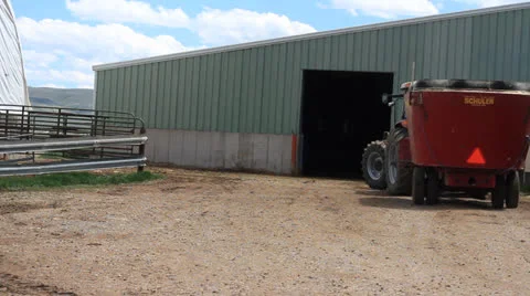 Grain tractor drives inside the barn Stock Footage 23822022