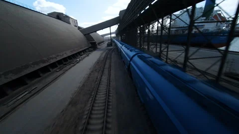 Grain train arrives at port for bulk carrier loading in industrial logistics hub Video stock 304561966