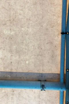 Grained wall texture and blue pipe Stock Photos