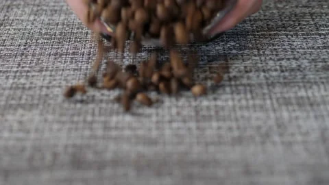 Grains are scattered on the table. Background consisting of roasted coffee beans Stock Footage 152045669