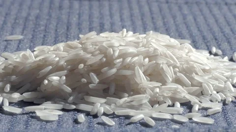 Grains of Basmati Fall onto a Pile of White Rice Stock Footage 71820699