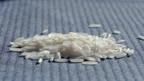 Grains of Basmati Rice Pour onto a Pile of White Rice Stock Footage 71820521