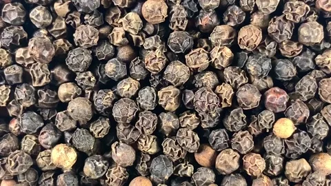 Grains of black pepper peas close-up rotate clockwise Video stock 131415239