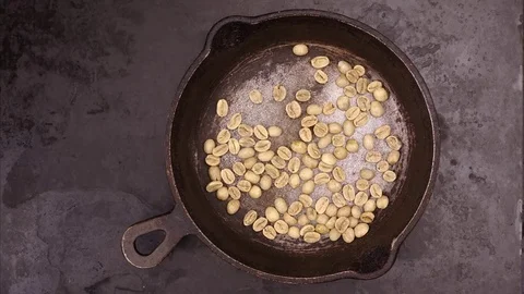 Grains of coffee are fried in a frying pan, stop motion, animation, 4K, UHD Stock Footage