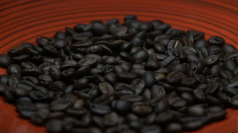 Grains of Coffee Close Up Rotating on a Red Plate Stock Footage 59949328