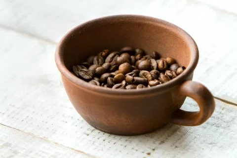 Grains of coffee in the cup. Stock Photos