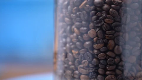 Grains of coffee in a glass jar Stock Footage 106059644