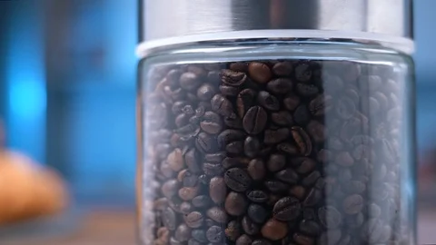 Grains of coffee in a glass jar Stock Footage 106059780