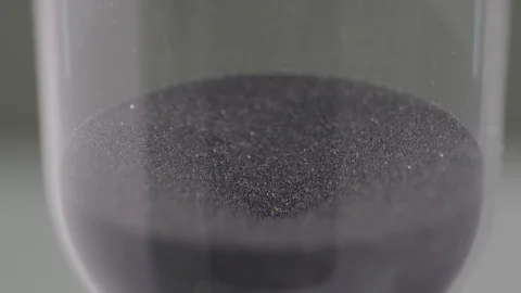 Grains &amp; Particles of Black Sand Falling Down in the Hourglass Body Stock Footage 126838180