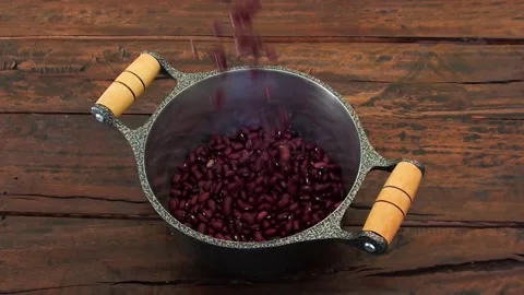 Grains of raw red beans falling into the pan Stock Footage 251352915