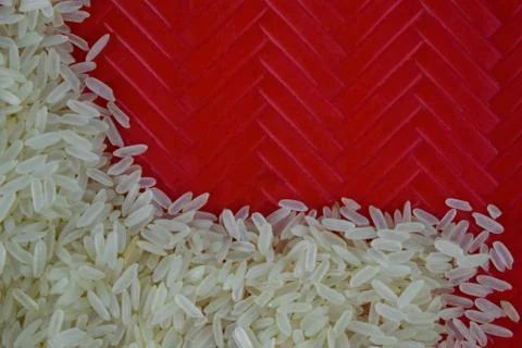 Grains of rice held in a designed red carpet where the rice grains are stacke Stock Photos