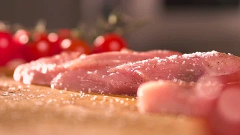 Grains of salt fall down at fillet of meat closeup Stock Footage 87065064