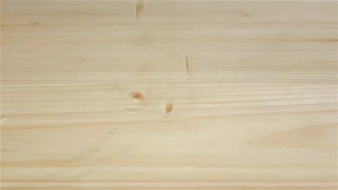 Grains wheat falling on wooden table, top view. Slow motion Stock-Footage 75488974