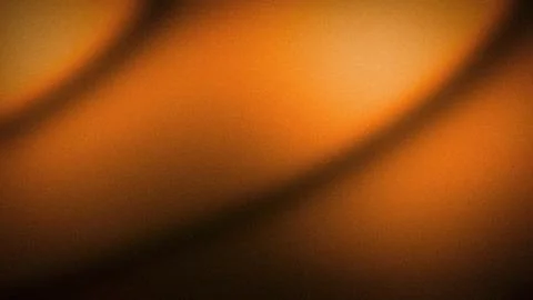 Grainy orange gradient abstract background texture with dark brown shadows .. Stock Photos
