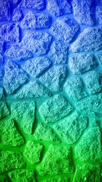 A grainy stone wall showcasing a smooth blend of vibrant blue and green hue.. Stock Photos