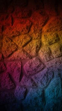 Grainy stone wall with a warm gradient transitioning from red to orange, ye.. Stock Photos