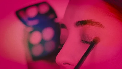 Grainy Stylish Close Up Shot of A Makeup Artist working on Young Girl's Eyes Stock-Footage 128962377