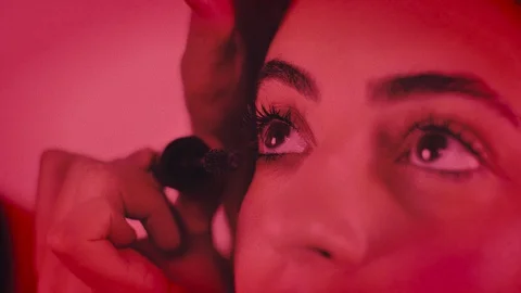 Grainy Stylish Close Shot of A Makeup Artist working on Young Girl's Eyelashes Video stock 129384826