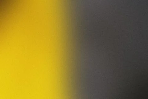 A grainy surface with a subtle gradient from yellow to dark gray Stock Photos