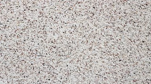 Grainy surface texture of the building facade. Granular plaster. Sandstone te Stock Photos