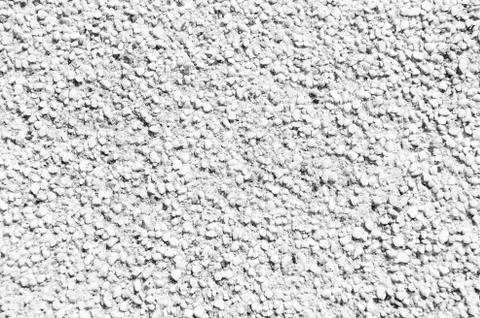 Grainy texture of decorative plaster. Tiny grains little stones in cement or Stock Photos