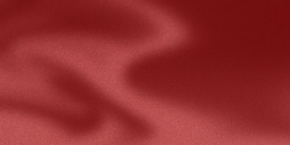 Grainy texture on a red background, highlighted by a beam of light Foto stock