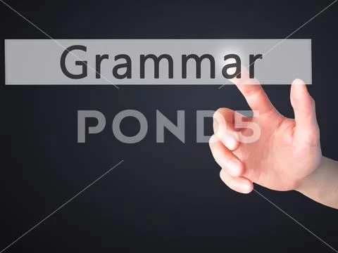 Grammar - Hand pressing a button on blurred background concept o Stock Photos