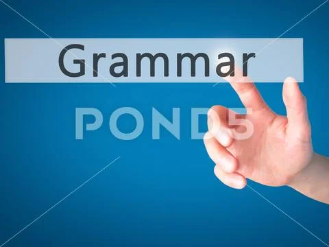 Grammar - Hand pressing a button on blurred background concept o Stock Photos