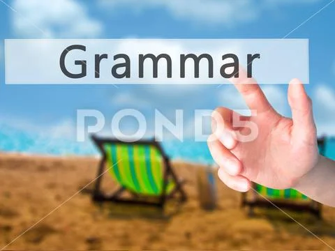 Grammar - Hand pressing a button on blurred background concept o Stock Photos